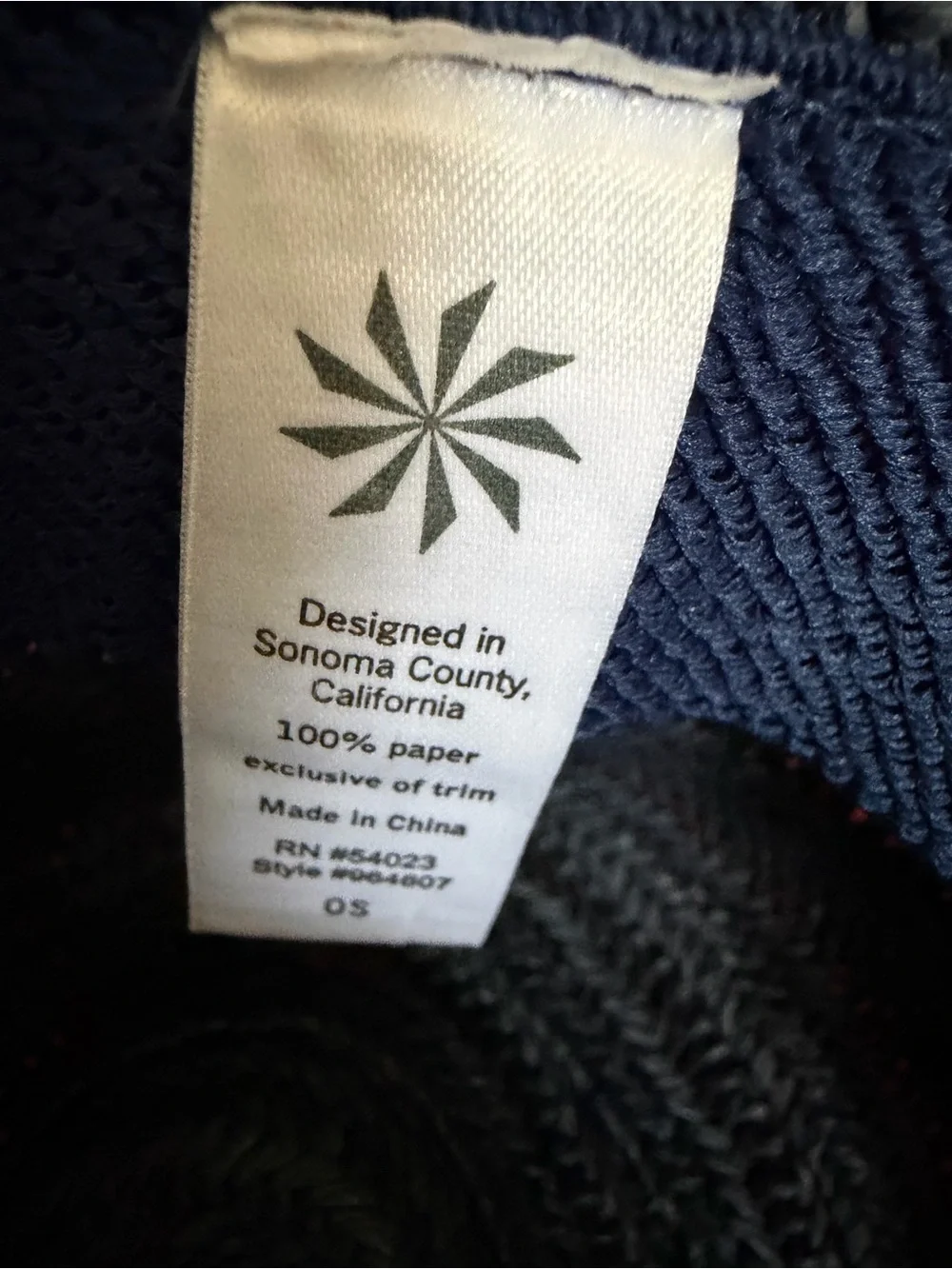Athleta dark navy woven straw hat with tan braided band.